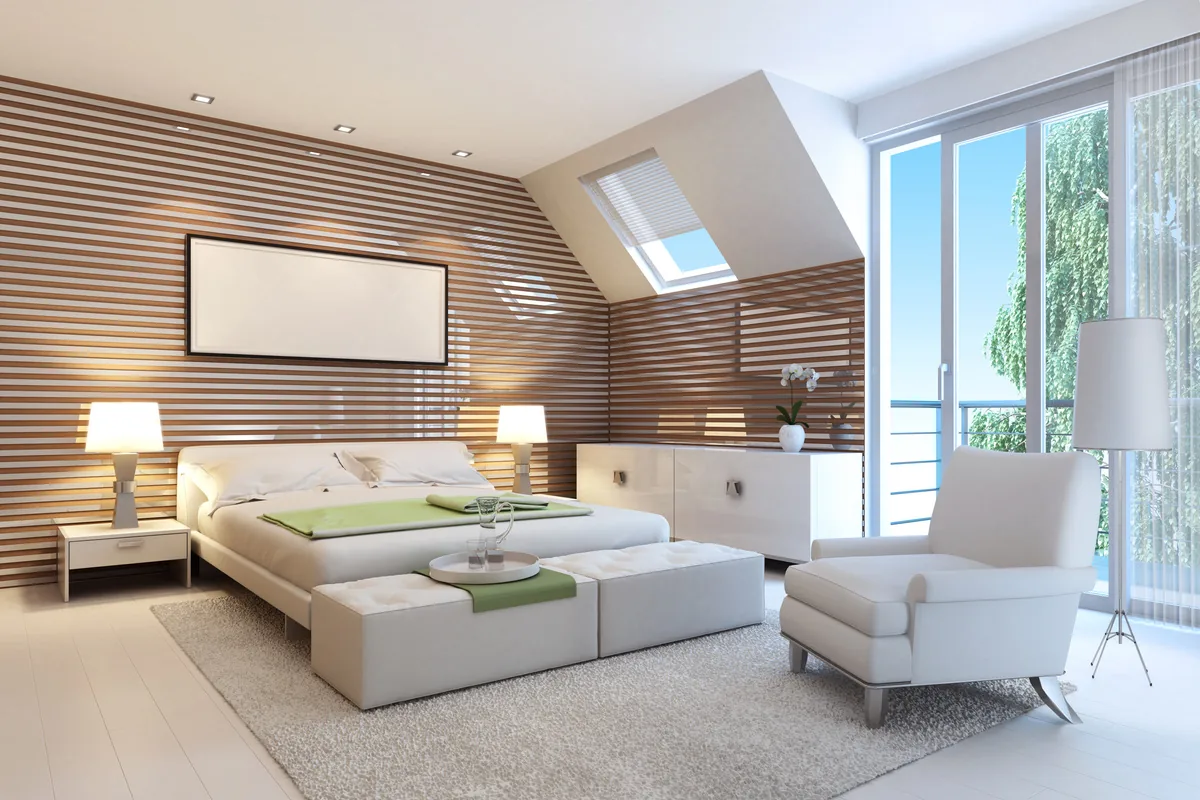 Attic-style bedroom with a horizontal timber slat wall, sloping ceiling with skylight, cream armchair and balcony doors.