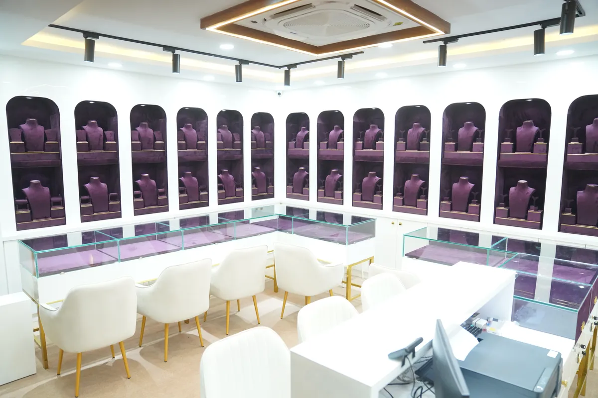 Jewellery showroom with arched purple velvet niches, glass counters and cream chairs